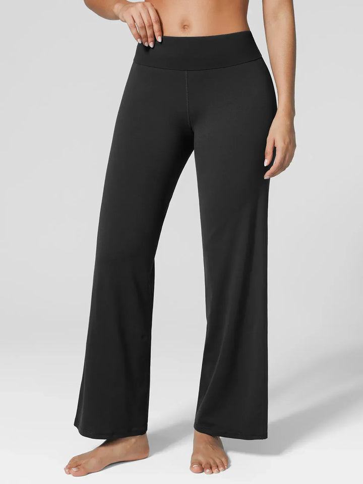 A model wearing a BRXL® Tummy Control Wide Leg Activewear Leggings in