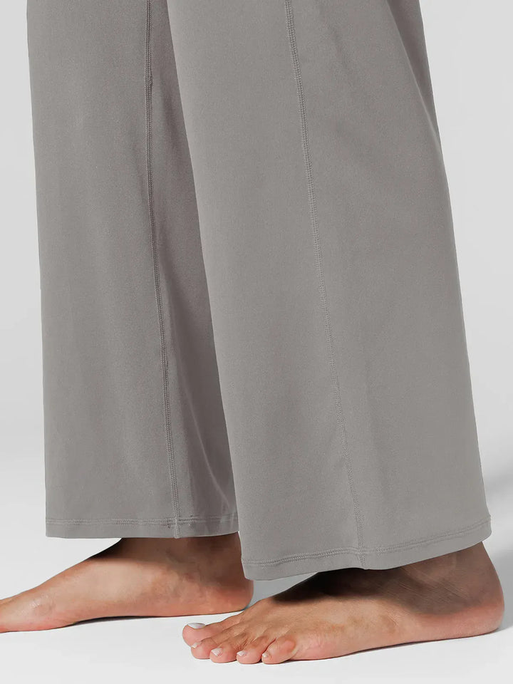 A model wearing a BRXL® Tummy Control Wide Leg Activewear Leggings in