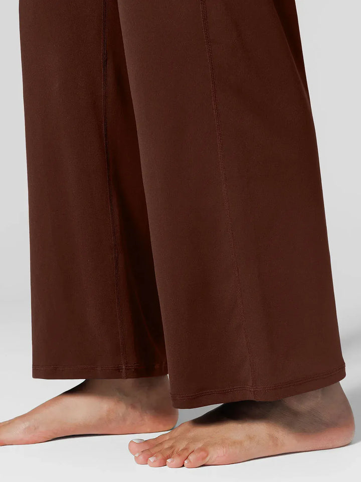 A model wearing a BRXL® Tummy Control Wide Leg Activewear Leggings in