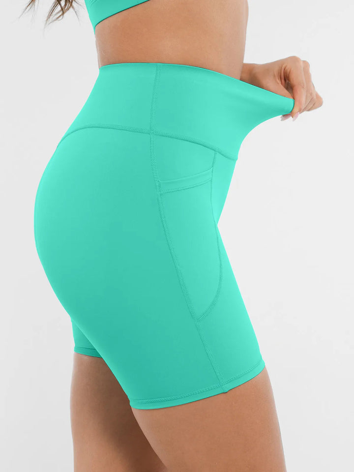Model showing the elasticity of the BRXL mint green biker shorts.