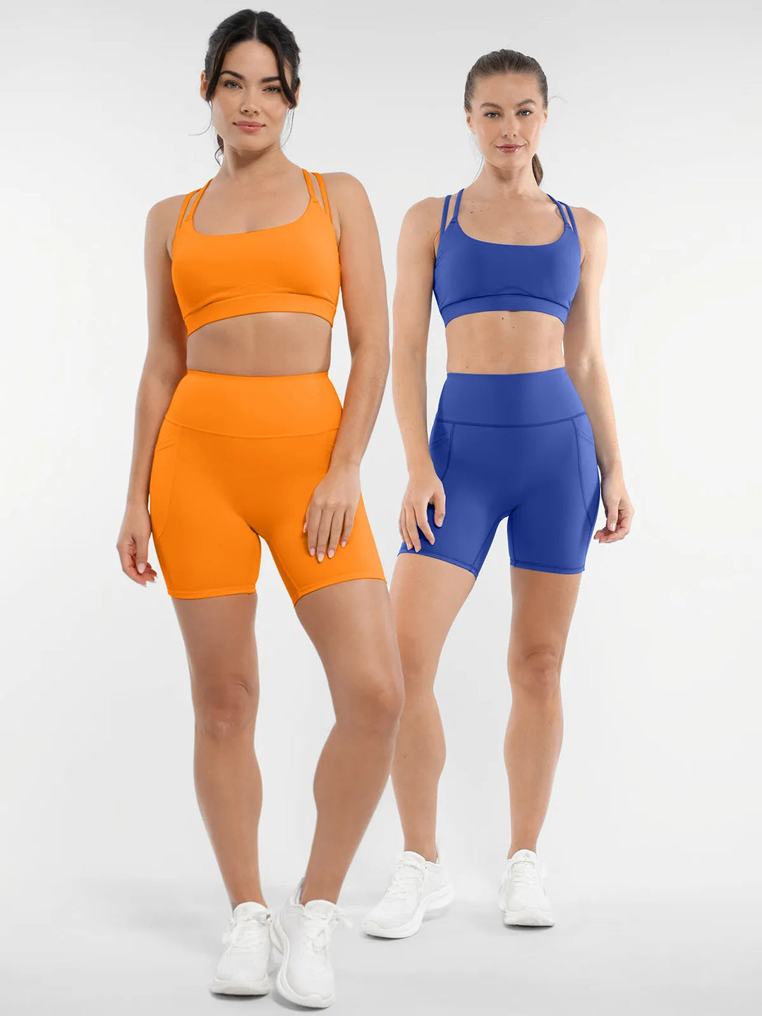 Two models wearing orange and blue BRXL matching workout sets.