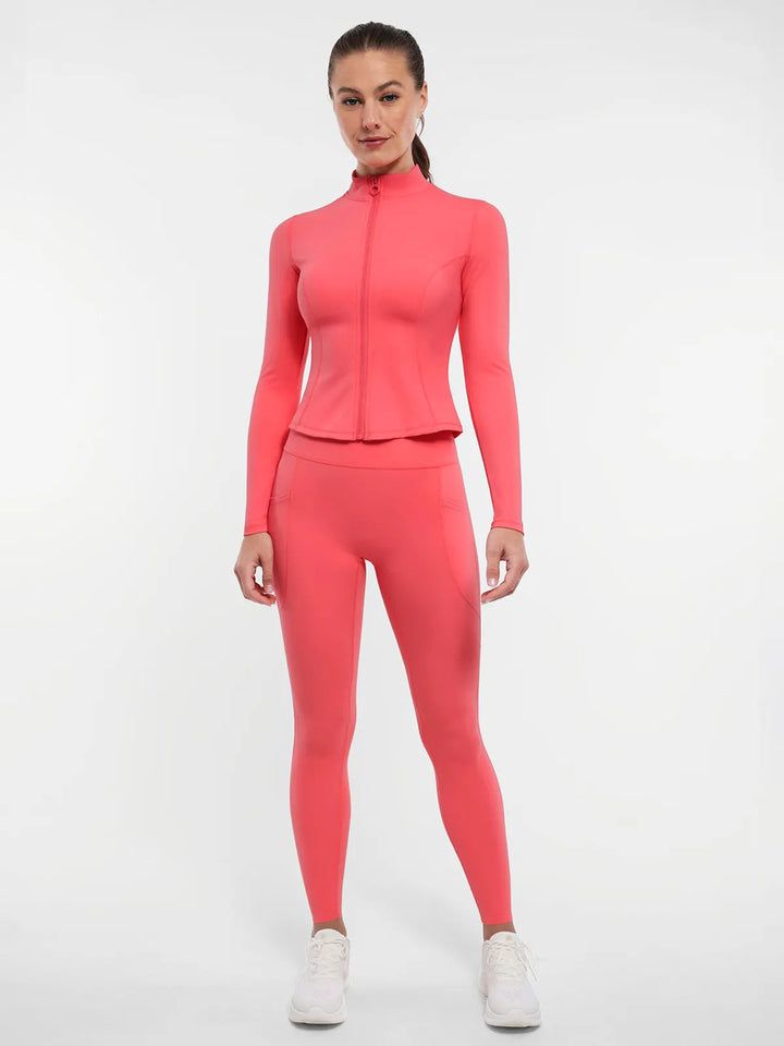 Woman wearing a BRXL athletic jacket and leggings.