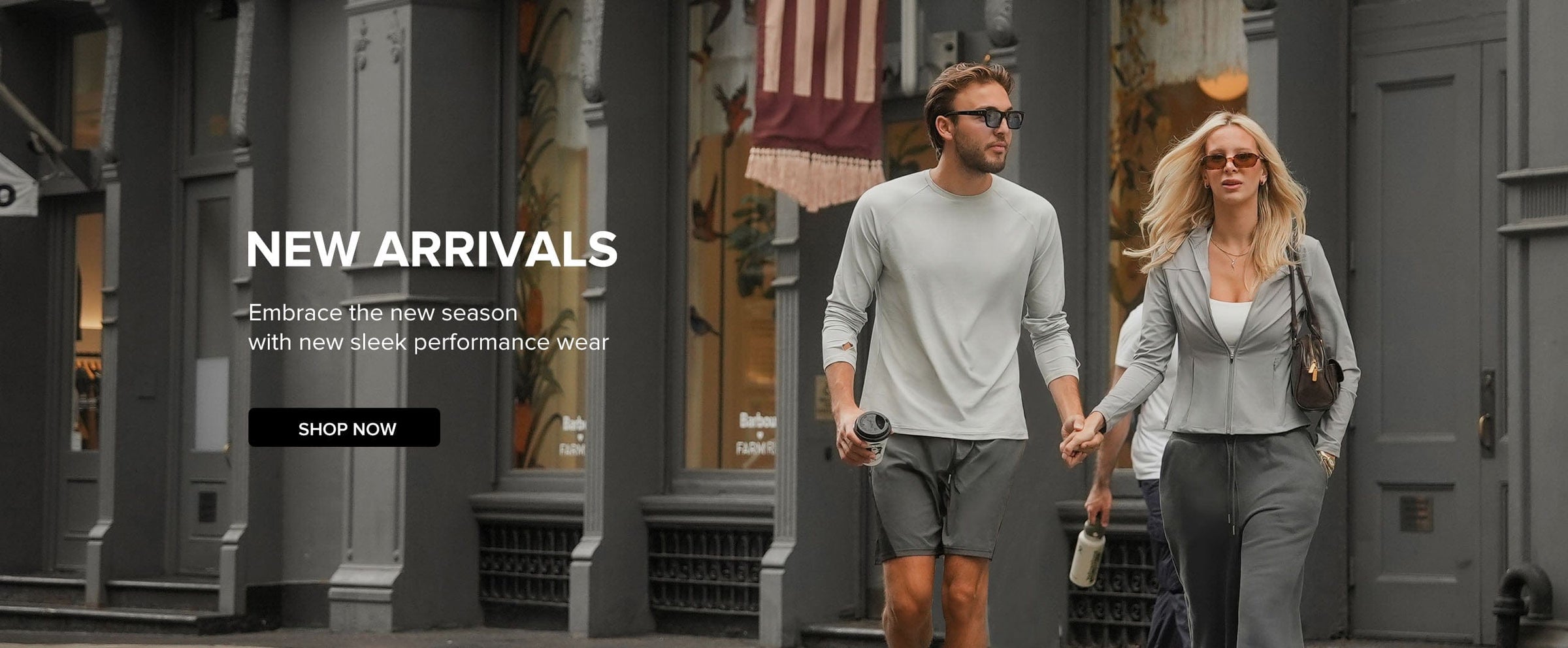 Man and woman walking together on a city street with promotional text for new arrivals.