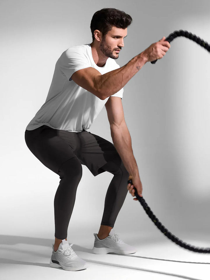 A model wearing a BRXL® 2-in-1 Training Pants for Men in