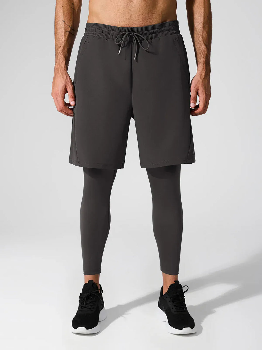 A model wearing a BRXL® 2-in-1 Training Pants for Men in Dark Gray / S