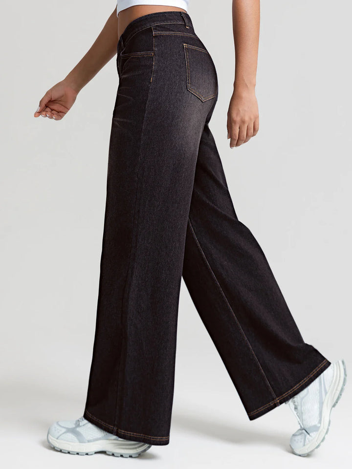 A model wearing a BRXL® Asymmetrical Mid Rise Washed Casual Wide Leg Jeans with Pockets