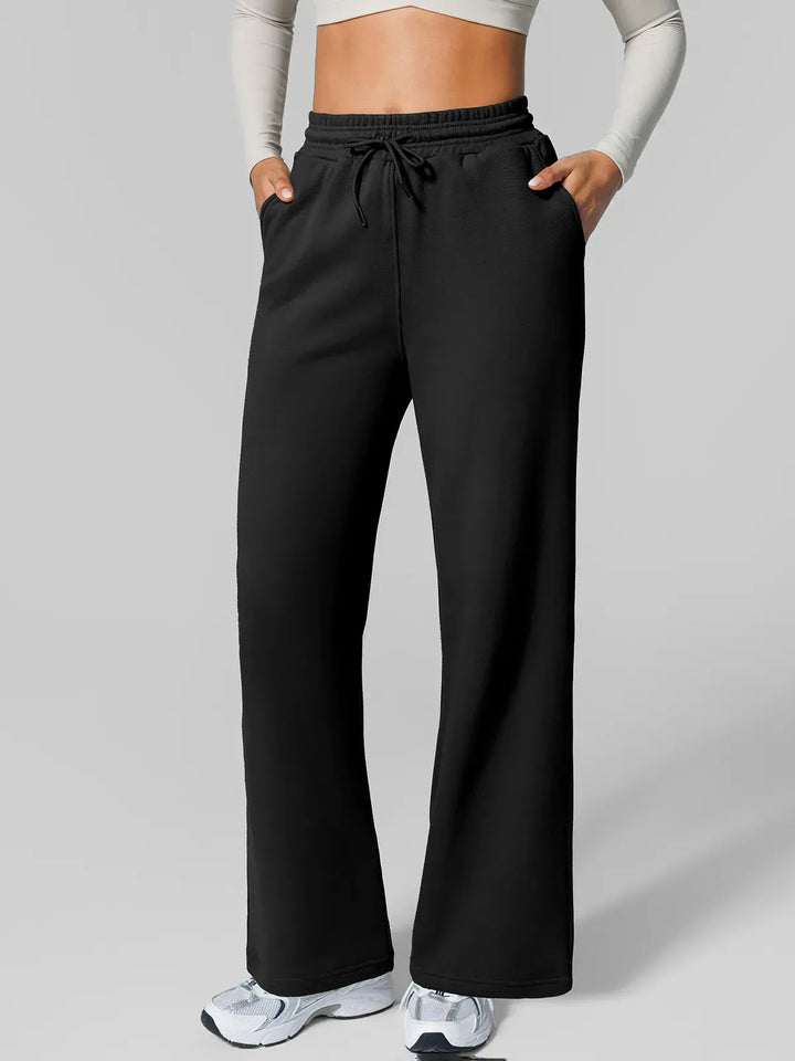 A model wearing a BRXL® Athleisure Drawstring Waist  Wide Leg Sweatpants in Black / XS