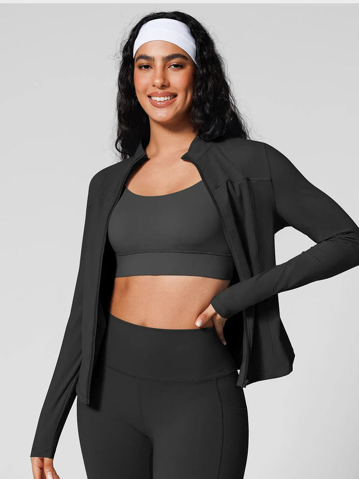A model wearing a BRXL® Athleisure Four Pockets Cropped Jacket,One Size Fits Most Sporty High-Waisted Leggings in Jacket / Black / XS