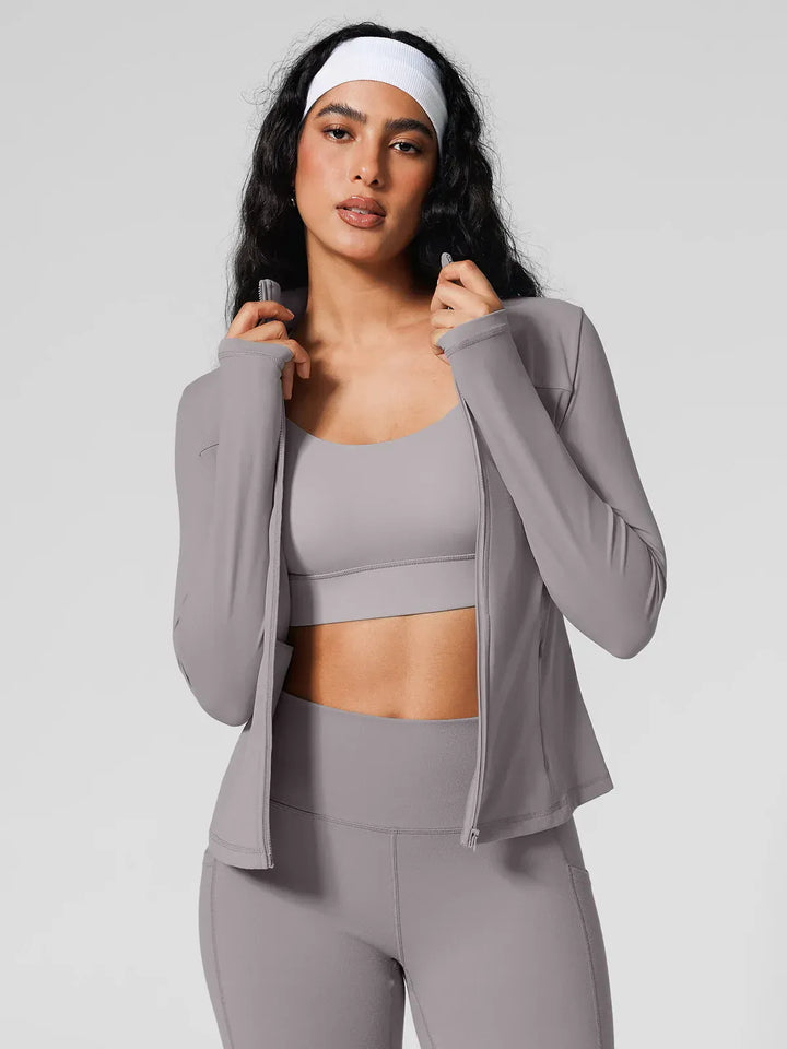 A model wearing a BRXL® Athleisure Hidden Pockets Cropped Jacket in Grey / XS