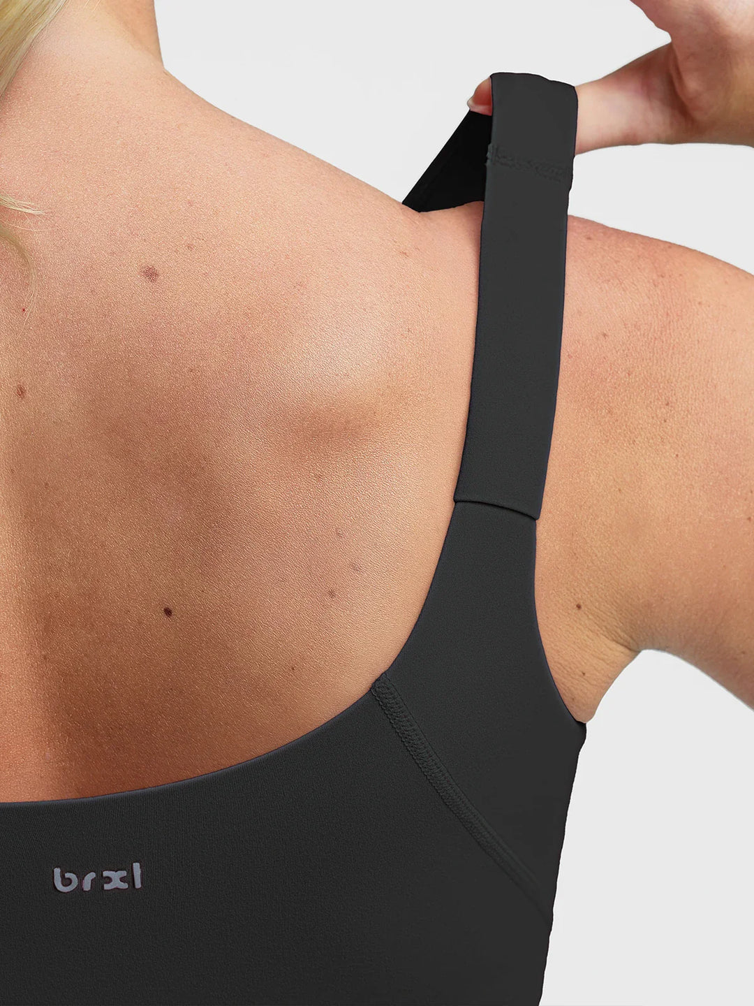 A model wearing a BRXL® B R X L™ Adjustable Strap U-Neck Cropped Tank Top
