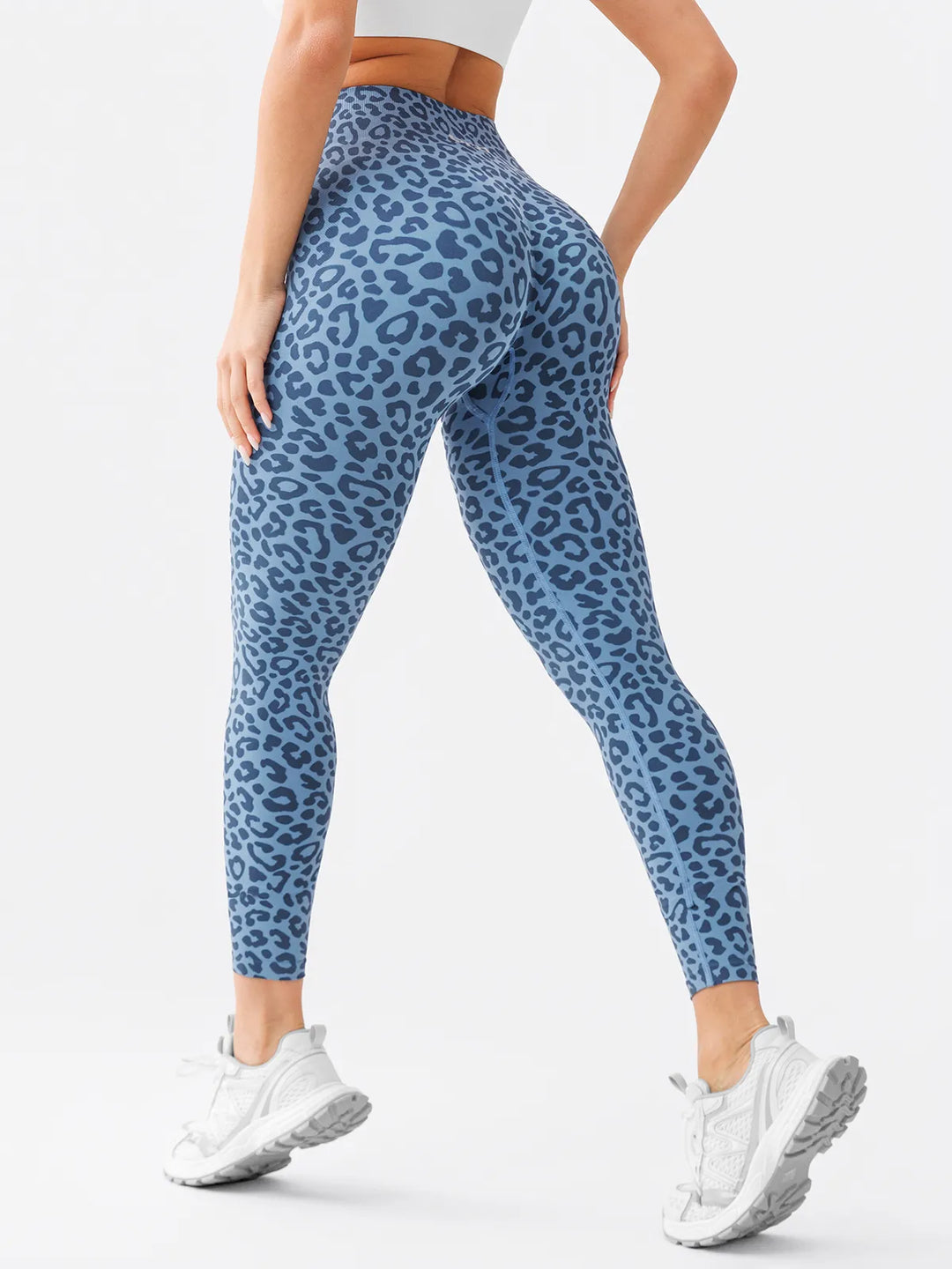 A model wearing a BRXL® B R X L™ Scrunch Butt Lifting Tummy Control High Waist Workout Leggings Blue Leopard (Core Sculpt) / XS