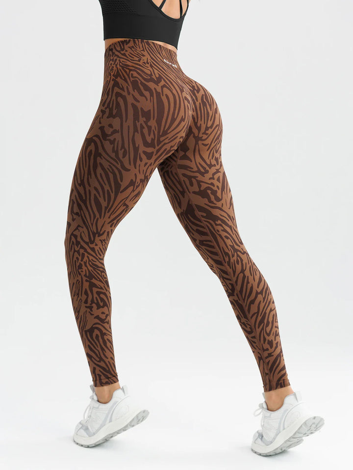 A model wearing a BRXL® B R X L™ Scrunch Butt Lifting Tummy Control High Waist Workout Leggings Brown Zebra (Core Sculpt) / XS