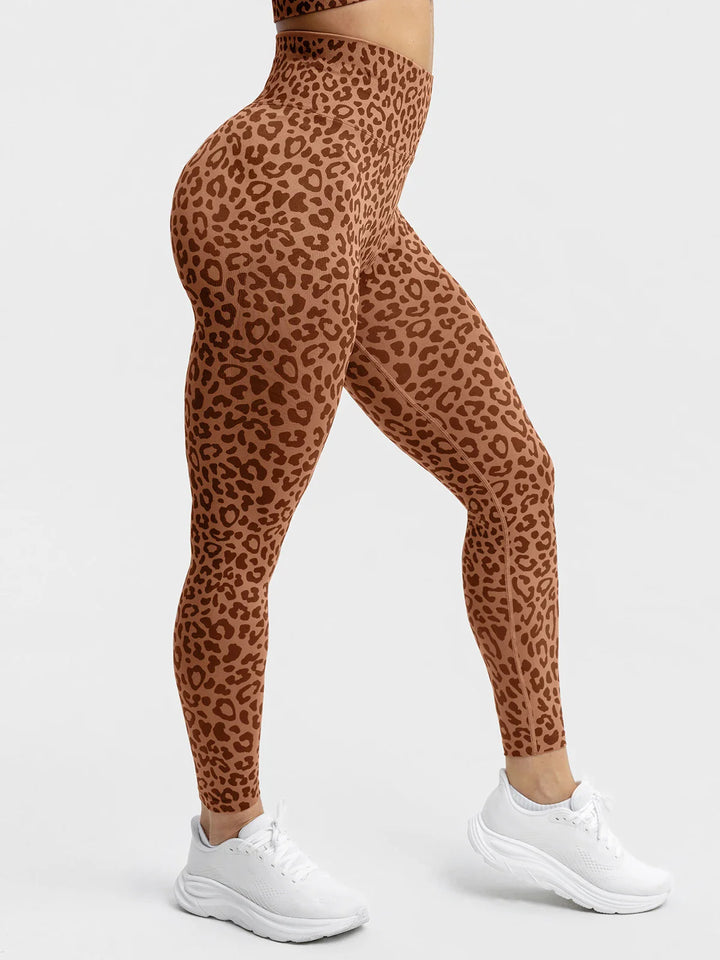 A model wearing a BRXL® B R X L® Scrunch Butt Lifting Tummy Control High Waist Workout Leggings Leopard / XS