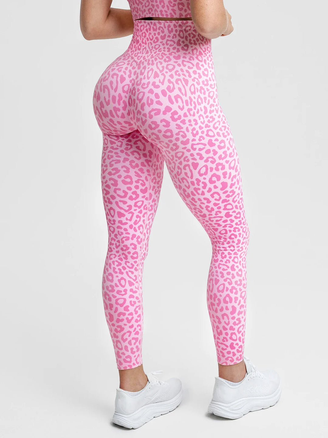 A model wearing a BRXL® B R X L® Scrunch Butt Lifting Tummy Control High Waist Workout Leggings Pink Leopard / XS