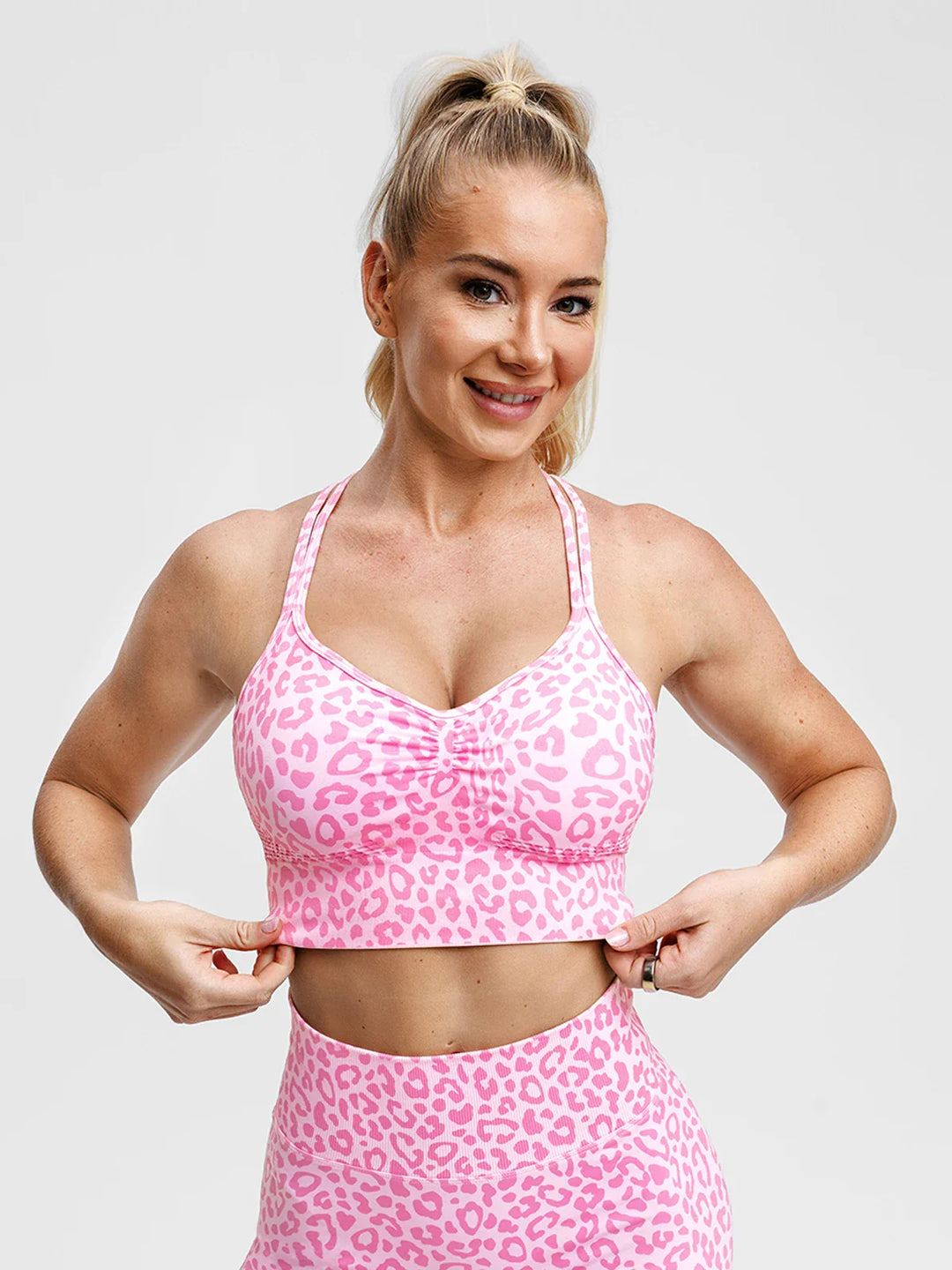 A model wearing a BRXL® B R X L® Seamless Criss Cross Spaghetti Racerback Sports Bra