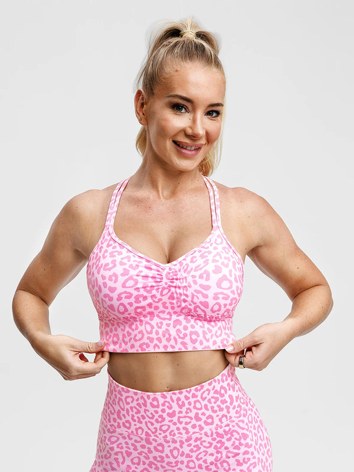 A model wearing a BRXL® B R X L® Seamless Criss Cross Spaghetti Racerback Sports Bra
