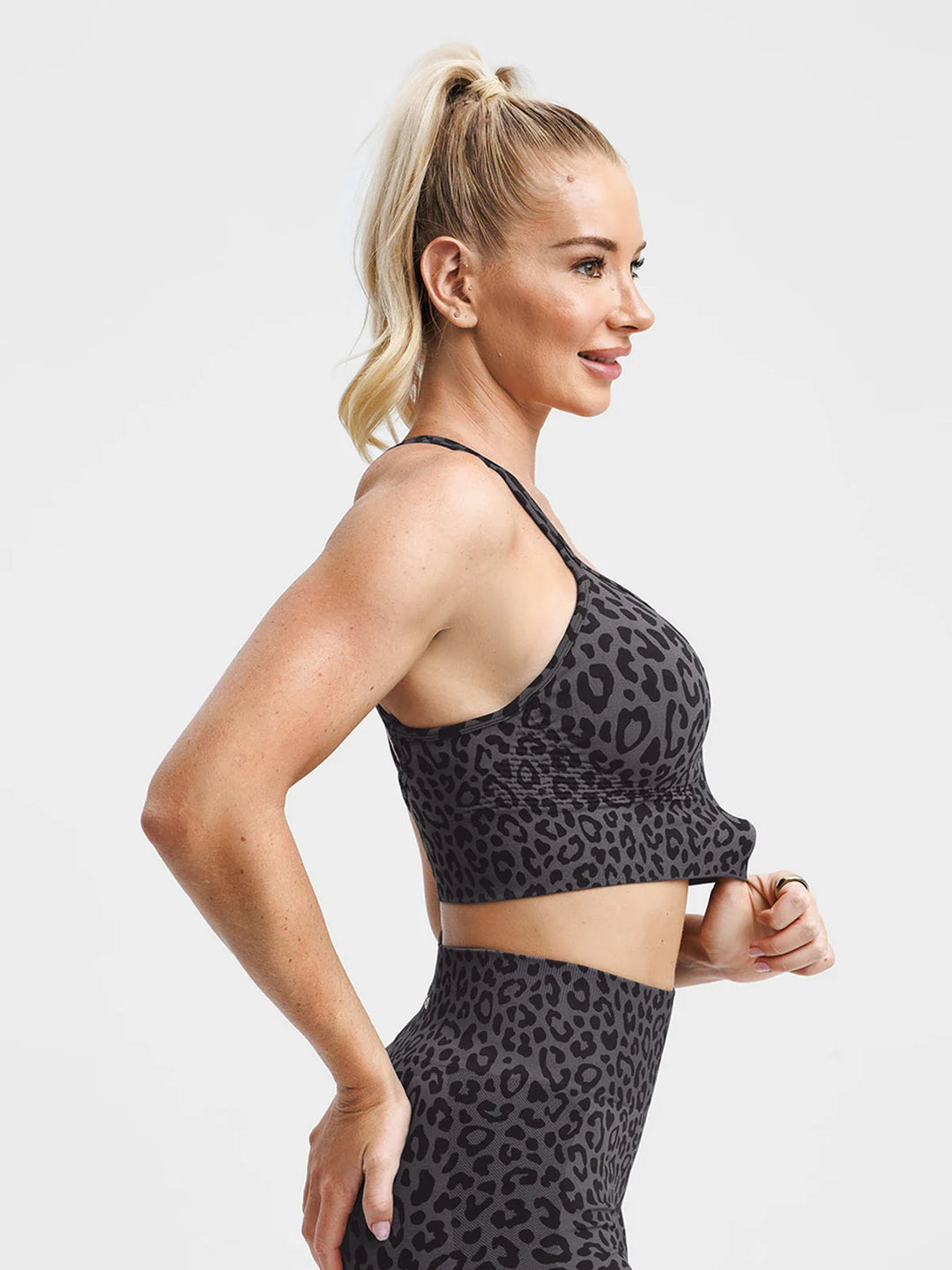 A model wearing a BRXL® B R X L® Seamless Criss Cross Spaghetti Racerback Sports Bra