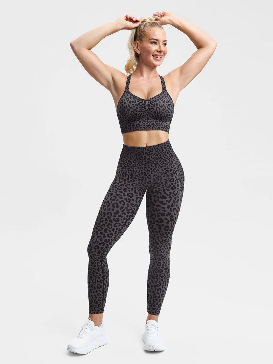 A model wearing a BRXL® B R X L® Seamless Criss Cross Spaghetti Racerback Sports Bra