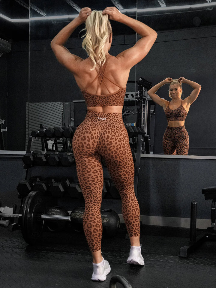A model wearing a BRXL® B R X L® Seamless Criss Cross Spaghetti Racerback Sports Bra