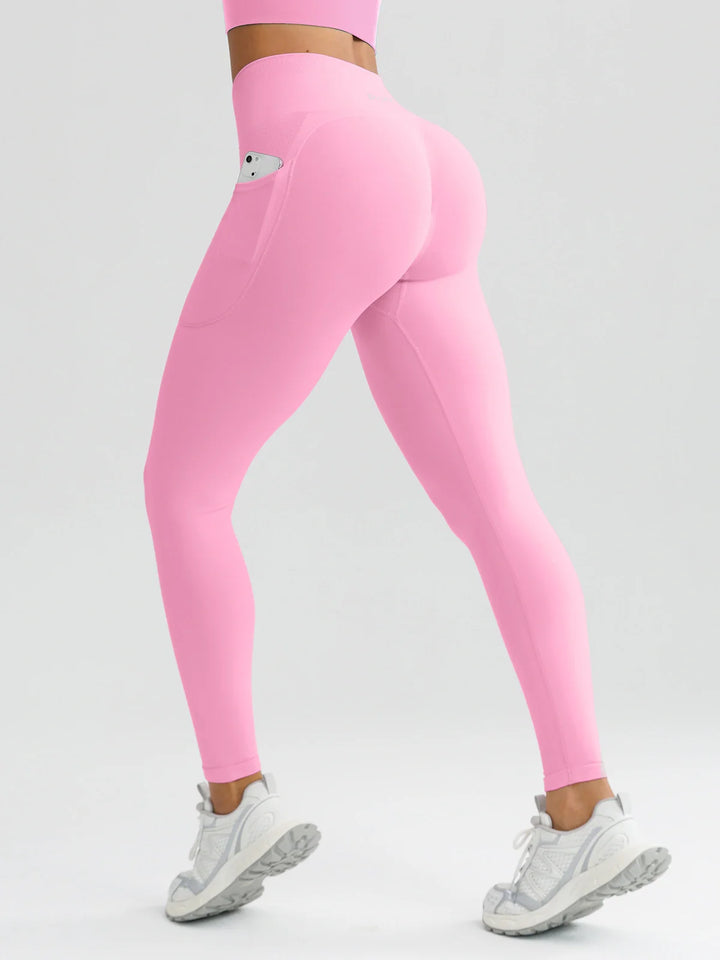 A model wearing a BRXL® B R X L™ Seamless High Waisted Butt-Lifting Leggings with Pockets