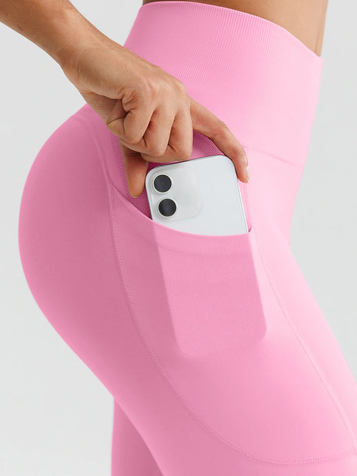 A model wearing a BRXL® B R X L™ Seamless High Waisted Butt-Lifting Leggings with Pockets