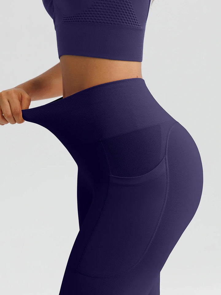 A model wearing a BRXL® B R X L™ Seamless High Waisted Butt-Lifting Leggings with Pockets