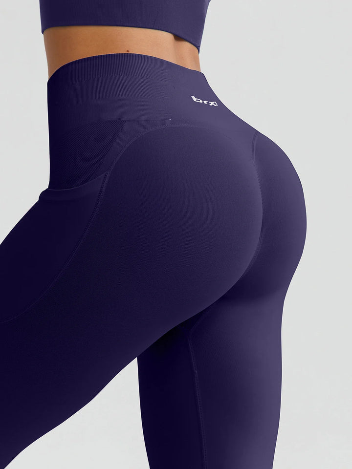 A model wearing a BRXL® B R X L™ Seamless High Waisted Butt-Lifting Leggings with Pockets