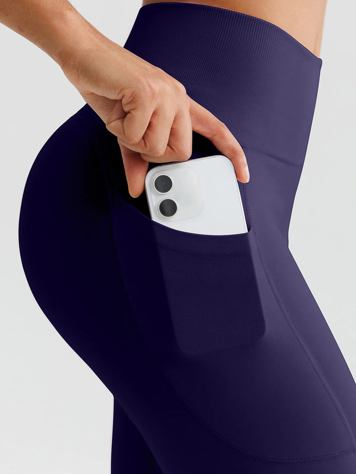 A model wearing a BRXL® B R X L™ Seamless High Waisted Butt-Lifting Leggings with Pockets