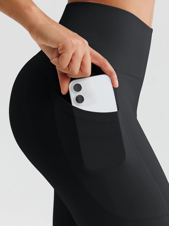 A model wearing a BRXL® B R X L™ Seamless High Waisted Butt-Lifting Leggings with Pockets
