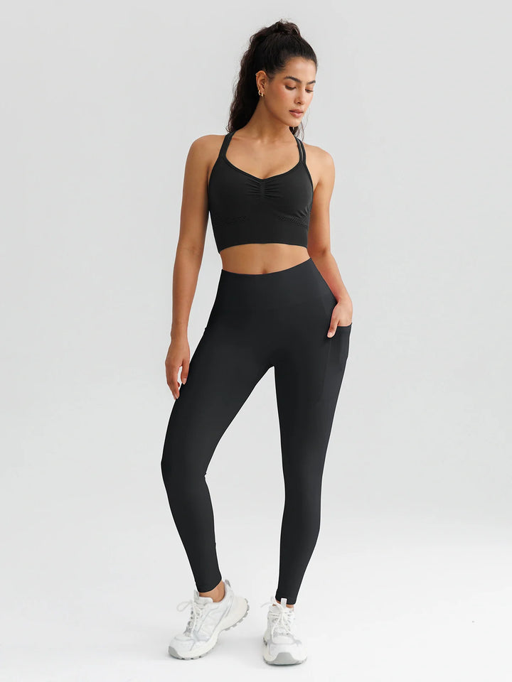 A model wearing a BRXL® B R X L™ Seamless High Waisted Butt-Lifting Leggings with Pockets