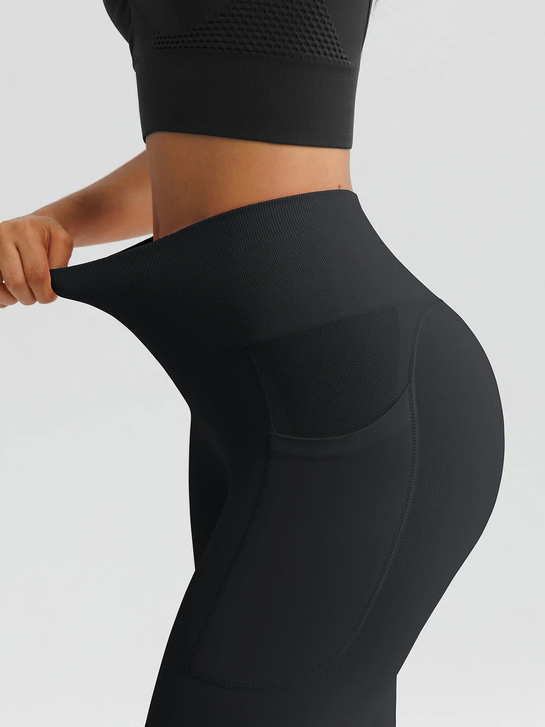 A model wearing a BRXL® B R X L™ Seamless High Waisted Butt-Lifting Leggings with Pockets