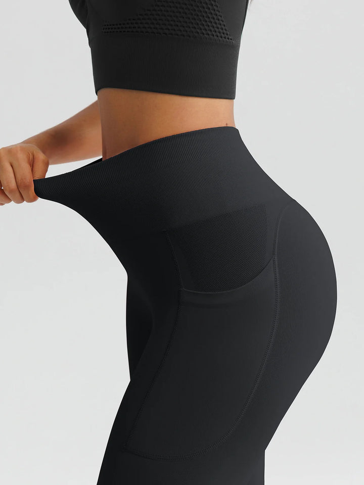A model wearing a BRXL® B R X L™ Seamless High Waisted Butt-Lifting Leggings with Pockets