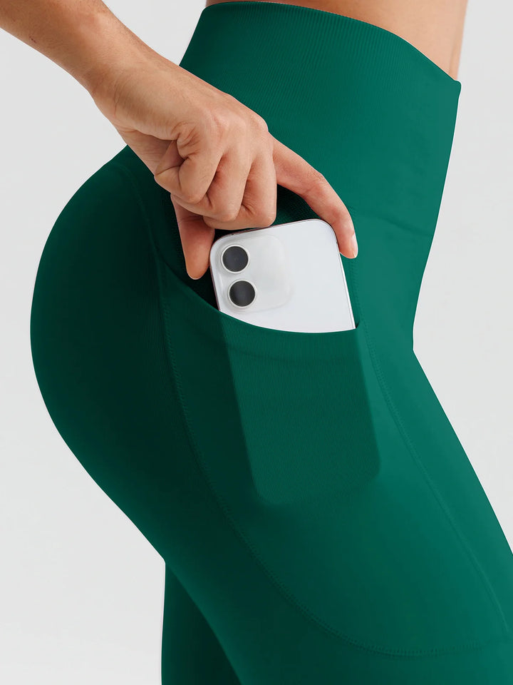 A model wearing a BRXL® B R X L™ Seamless High Waisted Butt-Lifting Leggings with Pockets