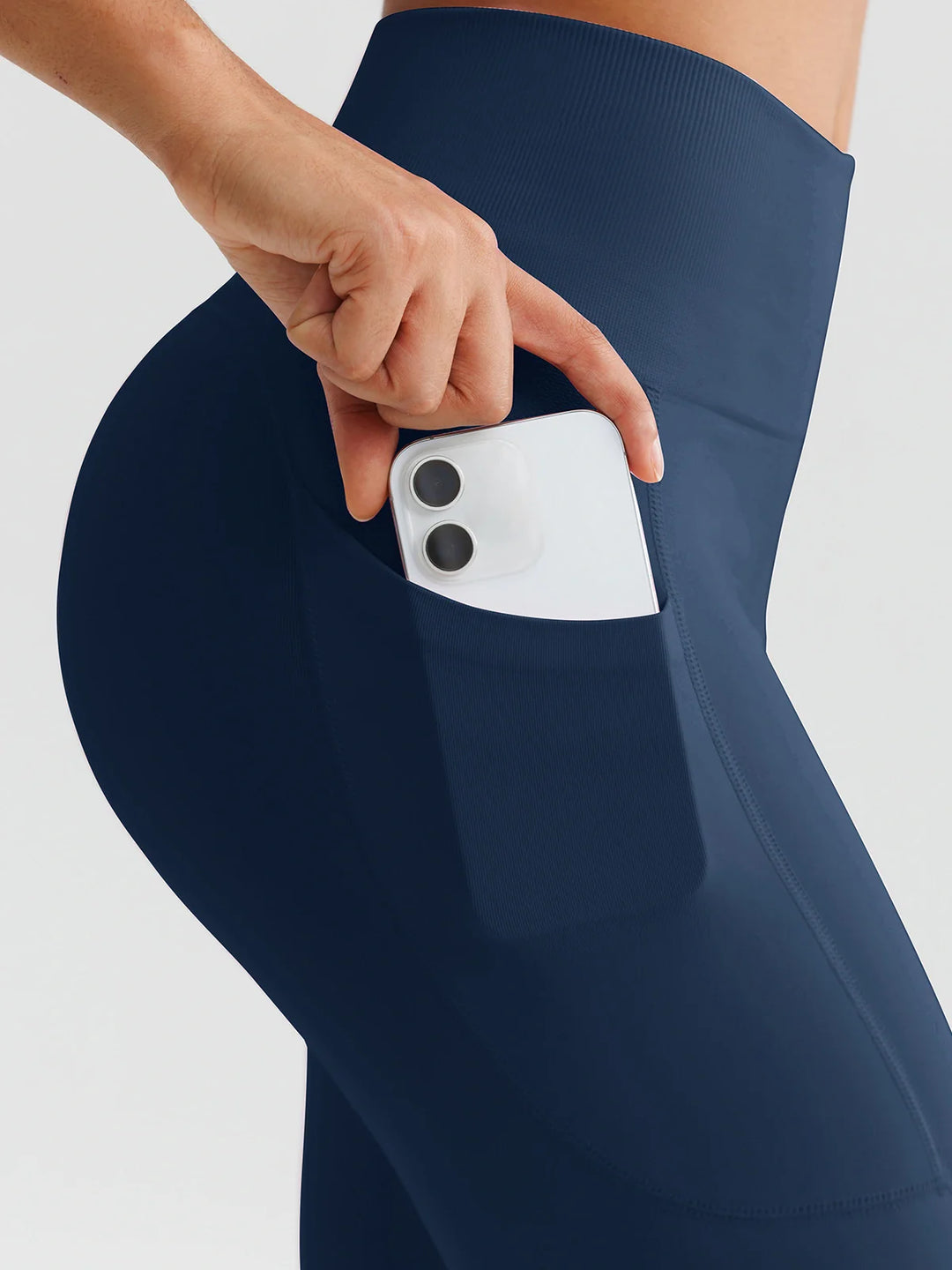 A model wearing a BRXL® B R X L™ Seamless High Waisted Butt-Lifting Leggings with Pockets