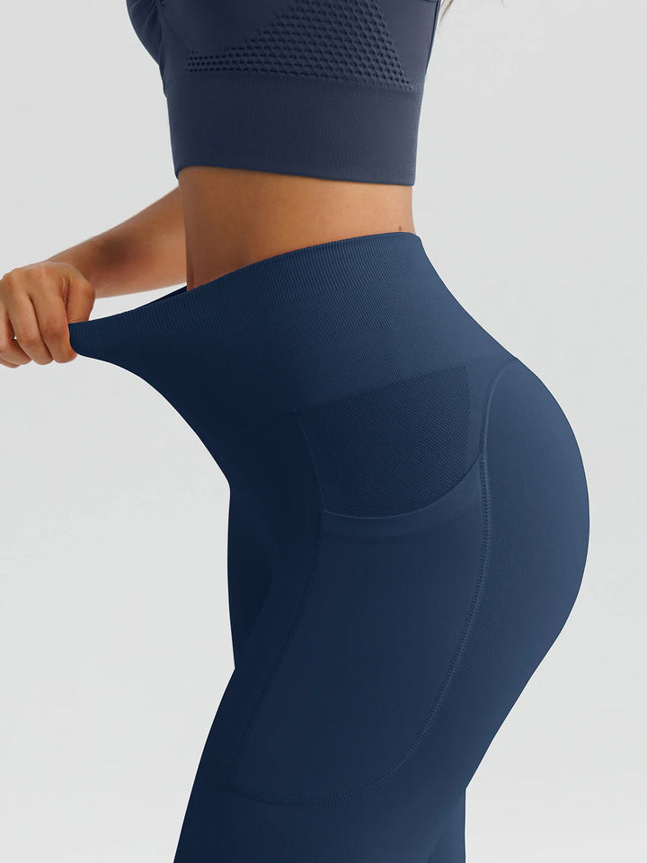 A model wearing a BRXL® B R X L™ Seamless High Waisted Butt-Lifting Leggings with Pockets