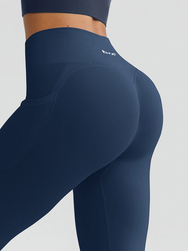 A model wearing a BRXL® B R X L™ Seamless High Waisted Butt-Lifting Leggings with Pockets