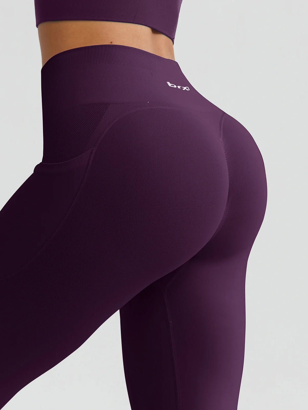 A model wearing a BRXL® B R X L™ Seamless High Waisted Butt-Lifting Leggings with Pockets