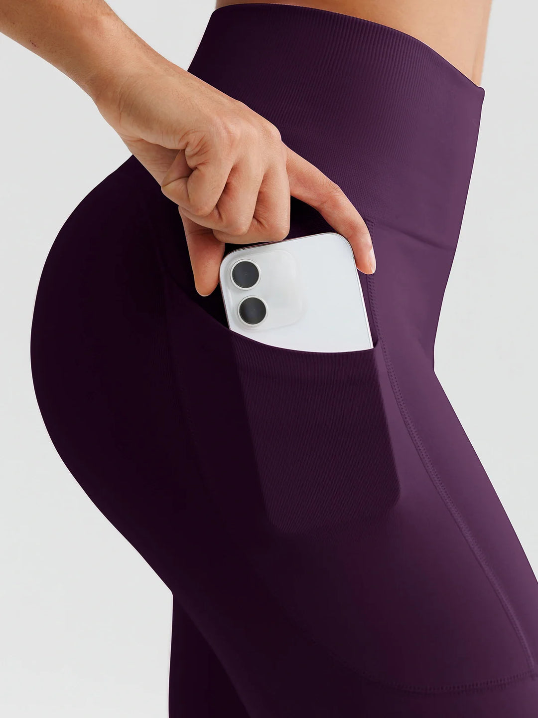 A model wearing a BRXL® B R X L™ Seamless High Waisted Butt-Lifting Leggings with Pockets