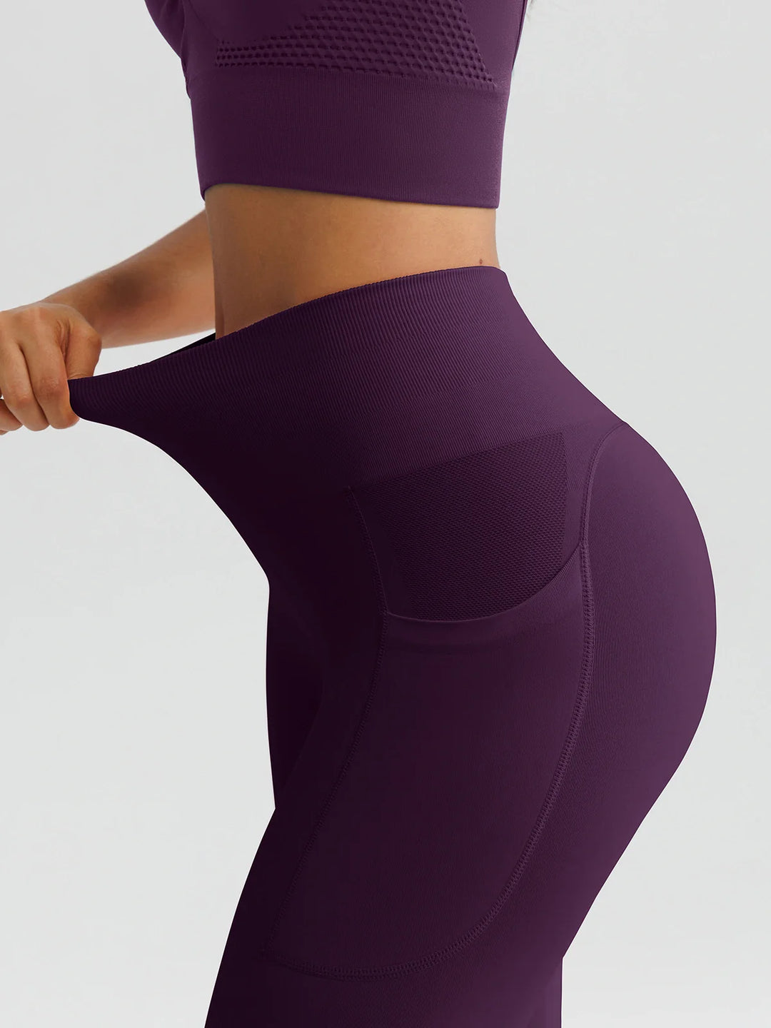 A model wearing a BRXL® B R X L™ Seamless High Waisted Butt-Lifting Leggings with Pockets