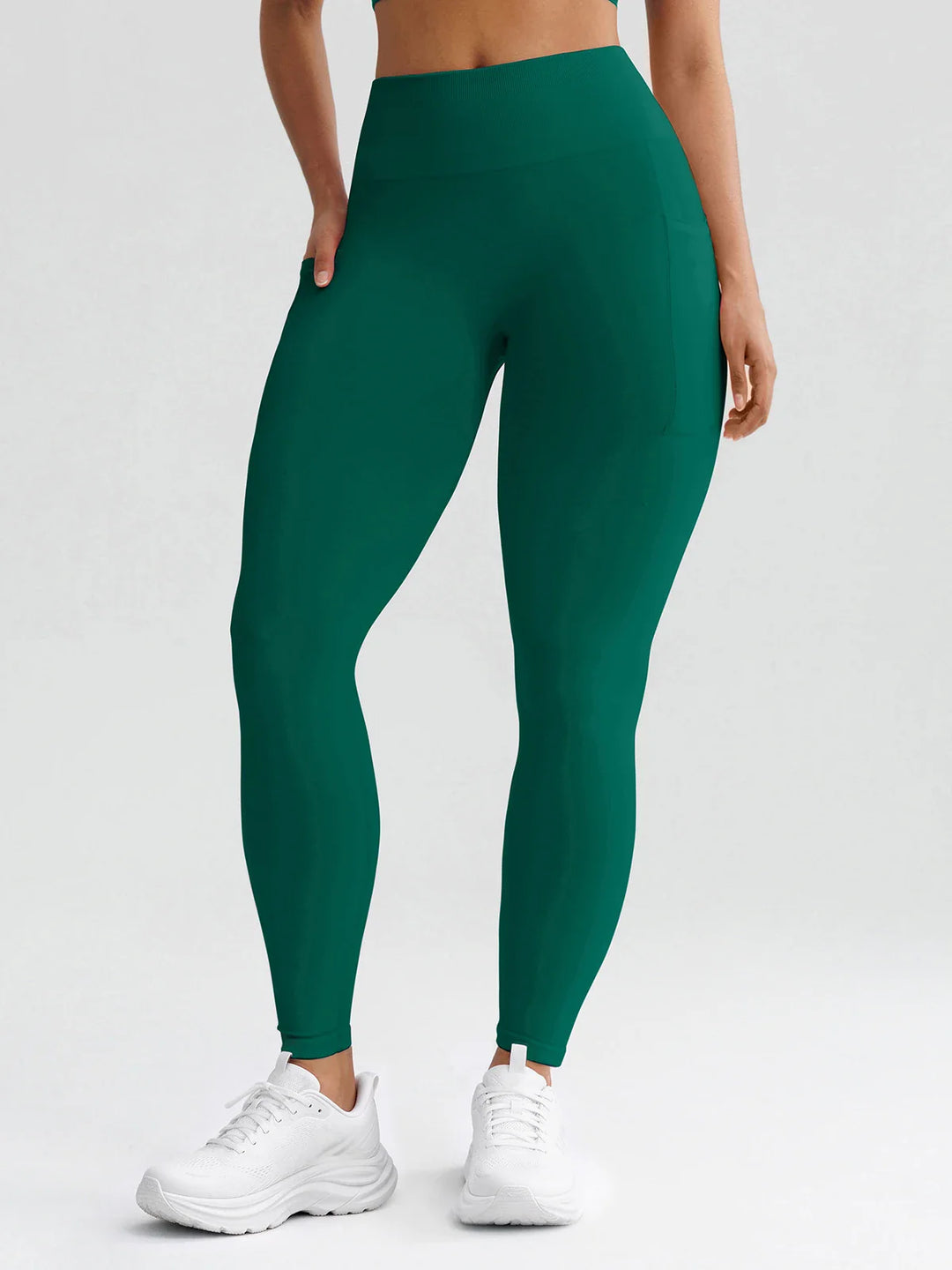 A model wearing a BRXL® B R X L® Seamless High Waisted Butt-Lifting Leggings with Pockets