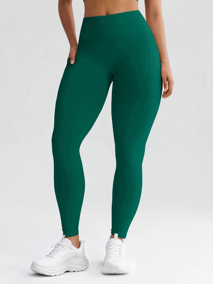 A model wearing a BRXL® B R X L® Seamless High Waisted Butt-Lifting Leggings with Pockets