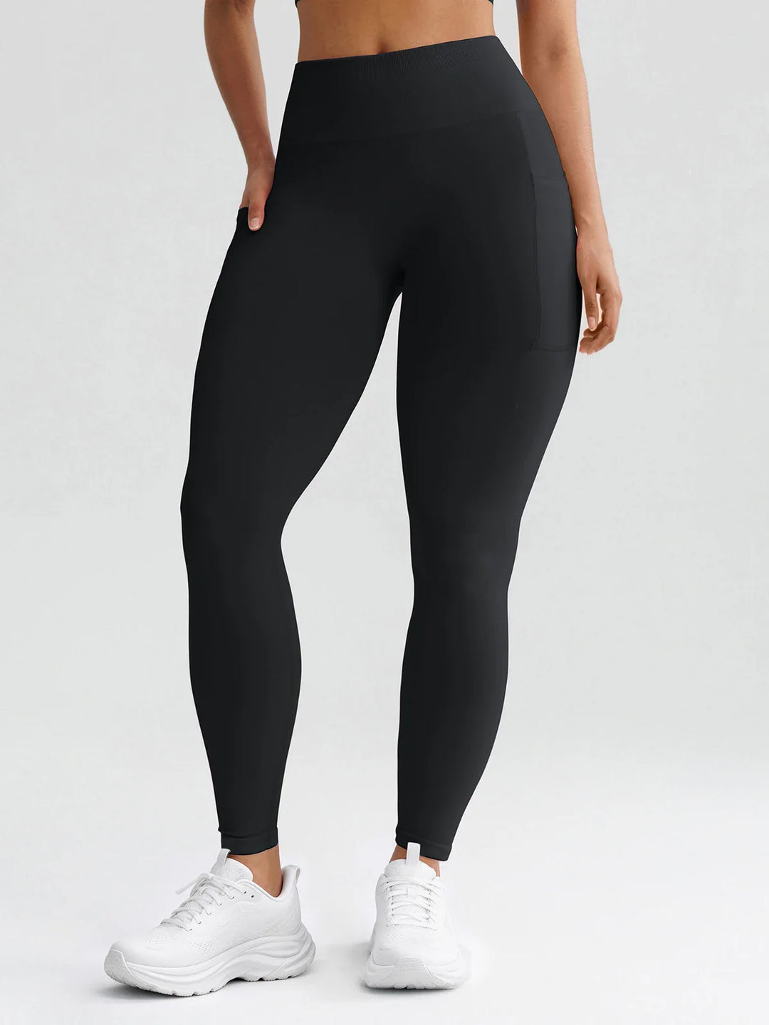 A model wearing a BRXL® B R X L® Seamless High Waisted Butt-Lifting Leggings with Pockets