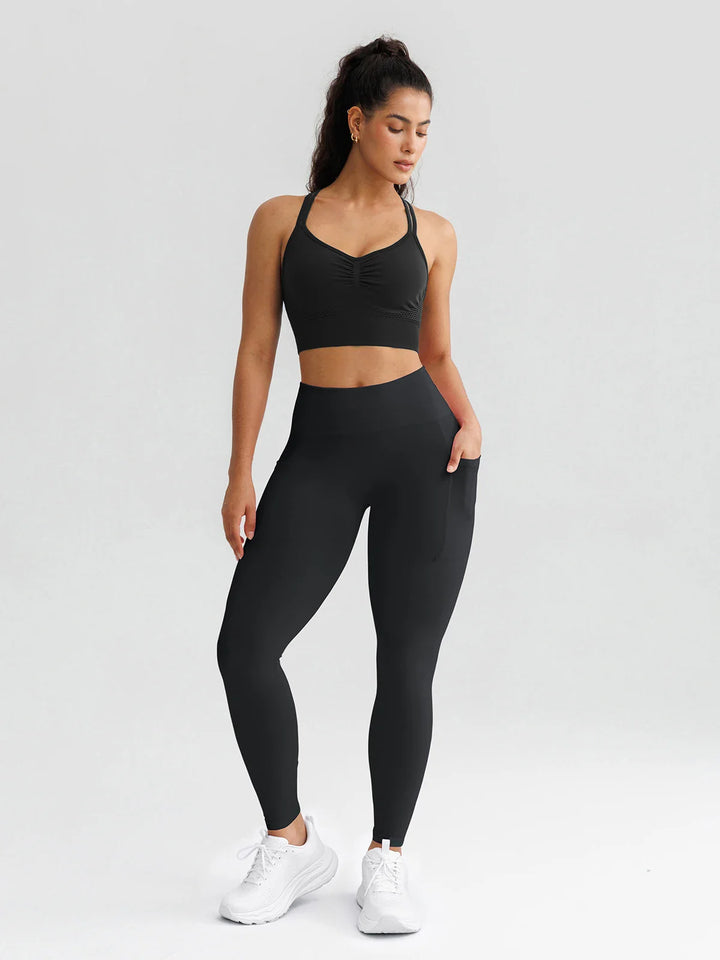 A model wearing a BRXL® B R X L® Seamless High Waisted Butt-Lifting Leggings with Pockets