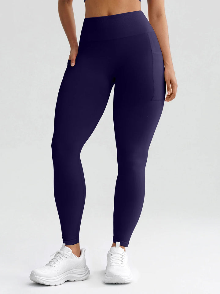 A model wearing a BRXL® B R X L® Seamless High Waisted Butt-Lifting Leggings with Pockets