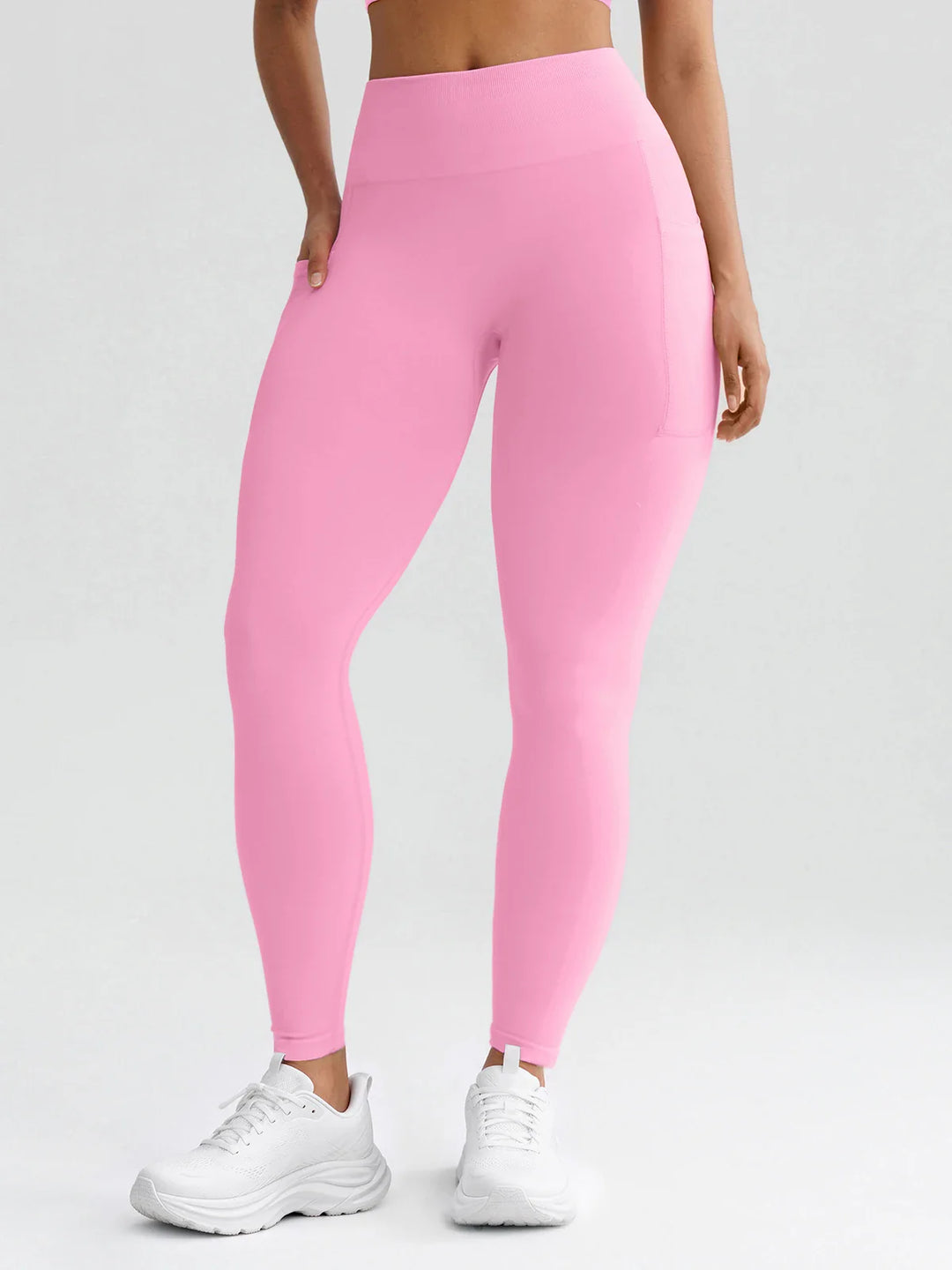 A model wearing a BRXL® B R X L® Seamless High Waisted Butt-Lifting Leggings with Pockets