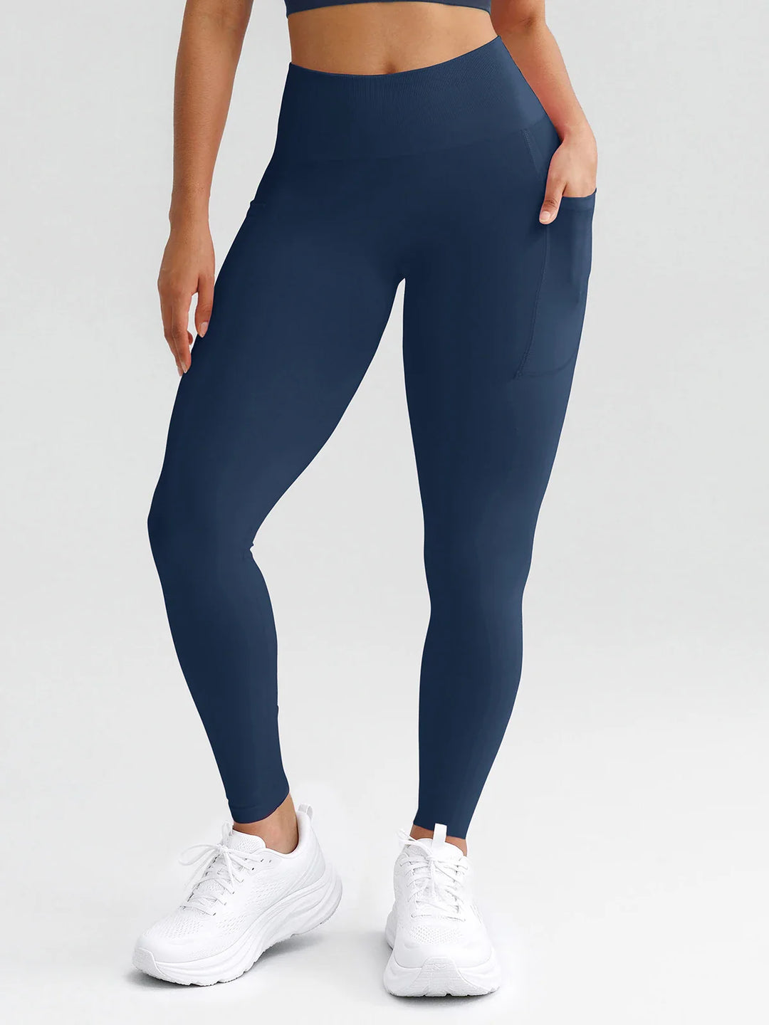 A model wearing a BRXL® B R X L® Seamless High Waisted Butt-Lifting Leggings with Pockets