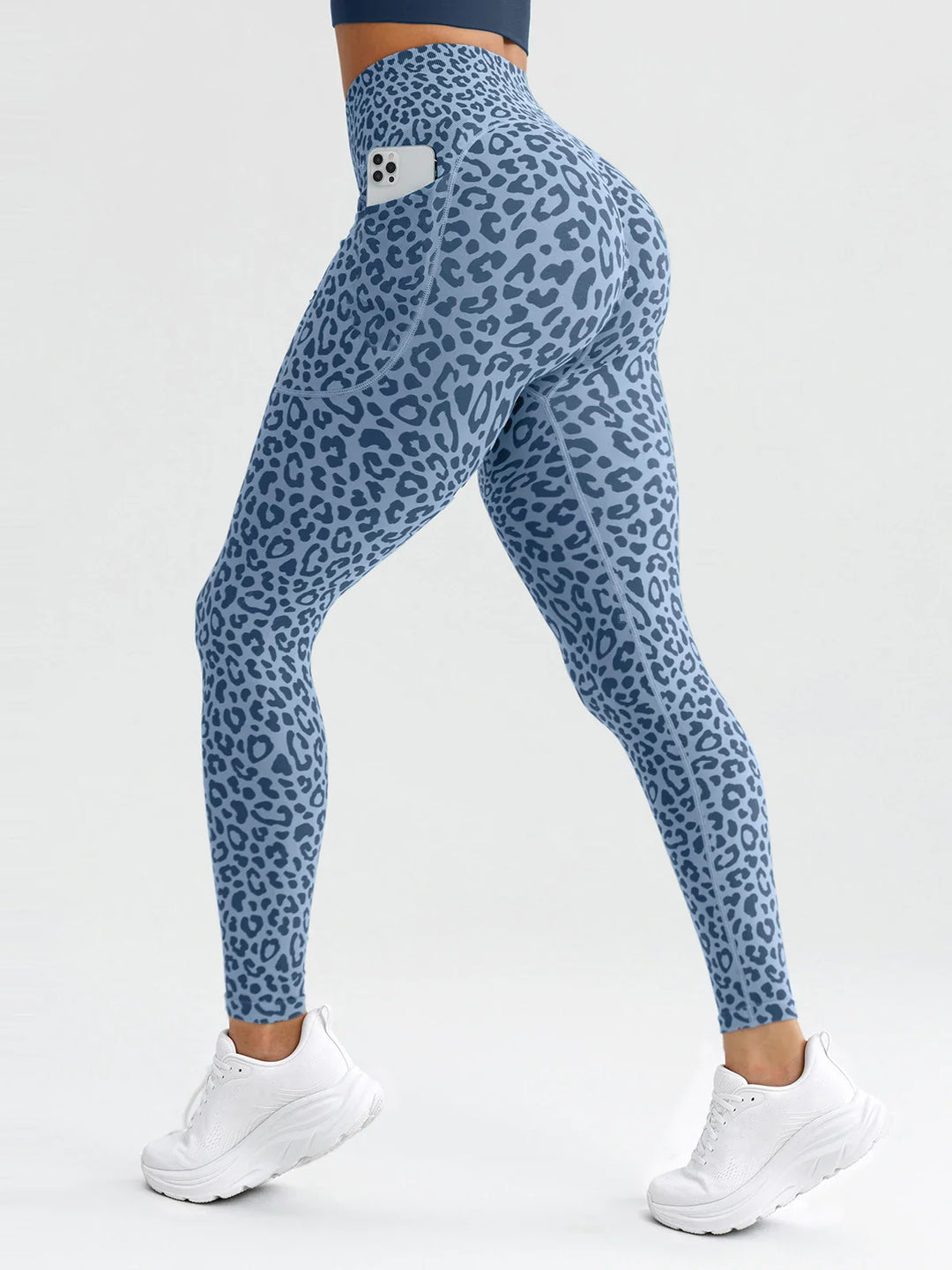 A model wearing a BRXL® B R X L® Seamless High Waisted Butt-Lifting Leggings with Pockets Blue Leopard / S