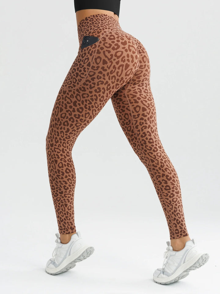 A model wearing a BRXL® B R X L® Seamless High Waisted Butt-Lifting Leggings with Pockets Leopard / XS