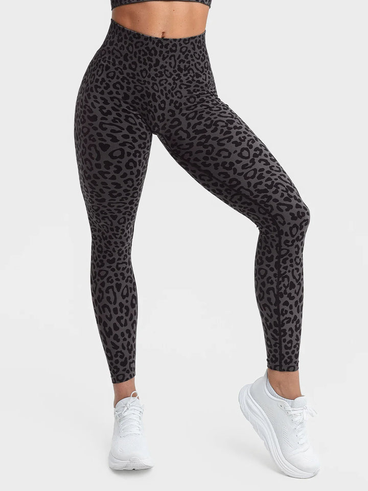 A model wearing a BRXL® B R X L®  Seamless Pro 2.0 High-Stretch LYCRA® High-Rise Sculpt Leggings Grey Leopard / XS
