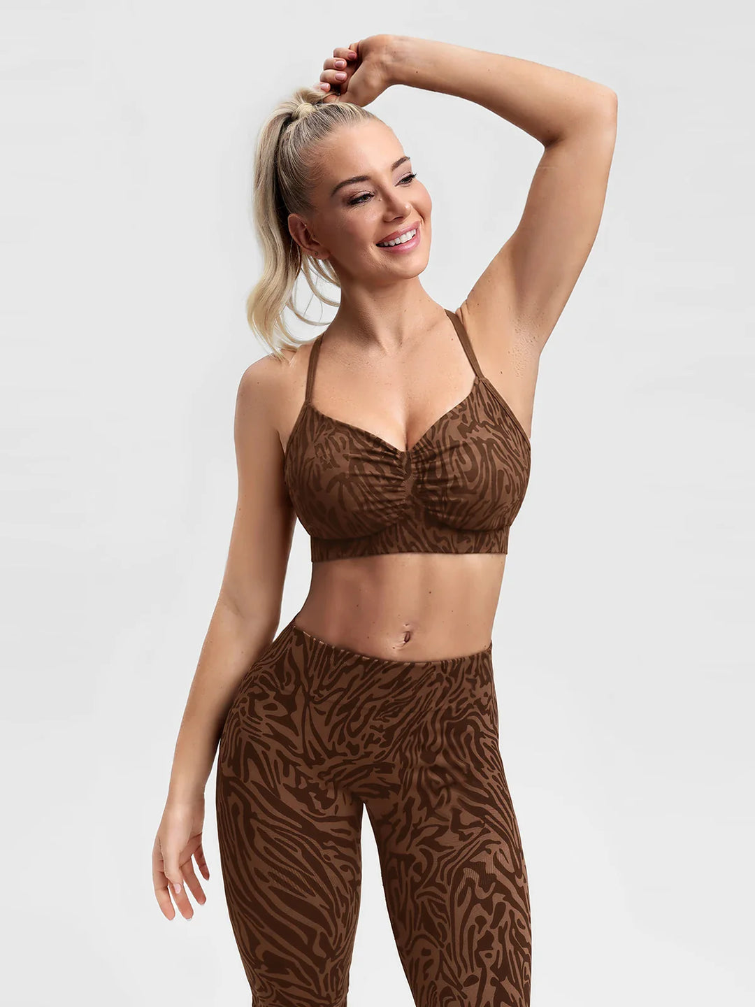 A model wearing a BRXL® B R X L®  V Neck Sculpt Seamless Ruched Y Back Sports Bra Brown Zebra / L